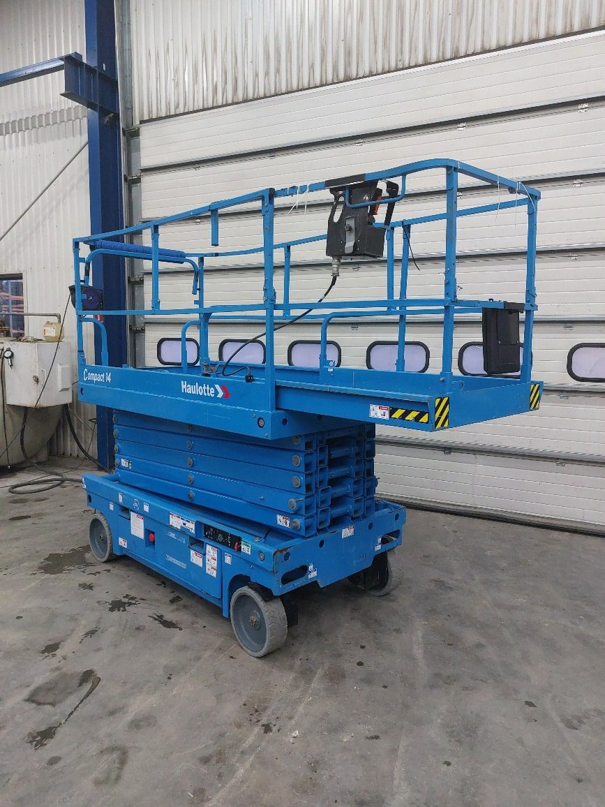 Podnośnik nożycowy Haulotte w magazynie.