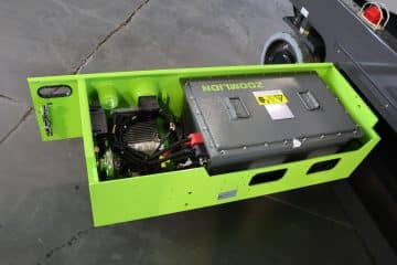 Green electric lifter by ZOOMLION with open battery compartment.