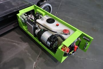 Green container with mechanisms and electrical components.