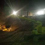 Night work of an excavator at a construction site.