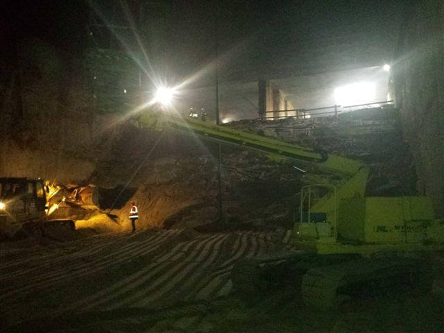 Night work of an excavator at a construction site.