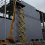 Installation of the facade at the stadium with a crane.