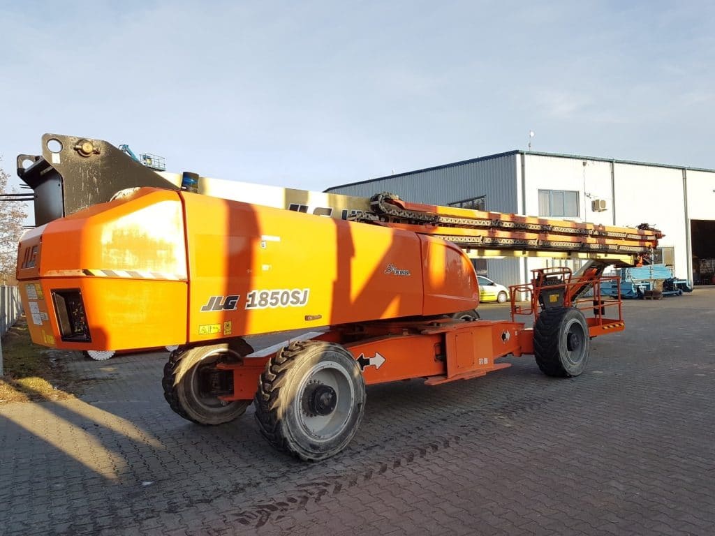 JLG 1850SJ telescopic boom lift on a construction site.