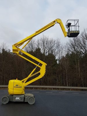 Yellow aerial lift on the road.