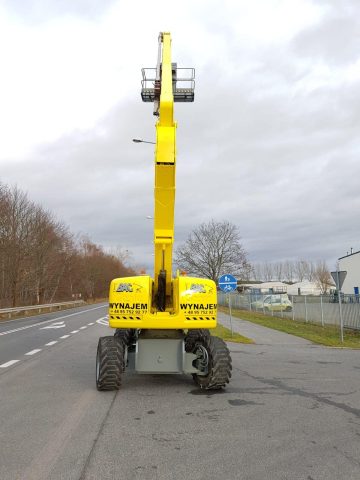 Scissor lift on the road, "rental" sign.