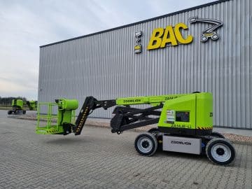 Green Zoomlion scissor lift in front of BAC warehouse.