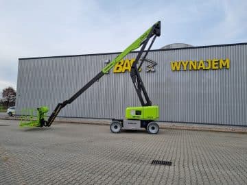 A basket lift in front of a building with a sign reading "Rental."