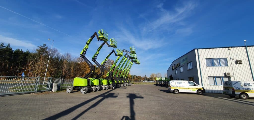 Aerial work platforms in front of the company's building.