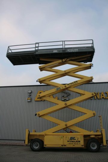 Yellow scissor lift in front of the company building.