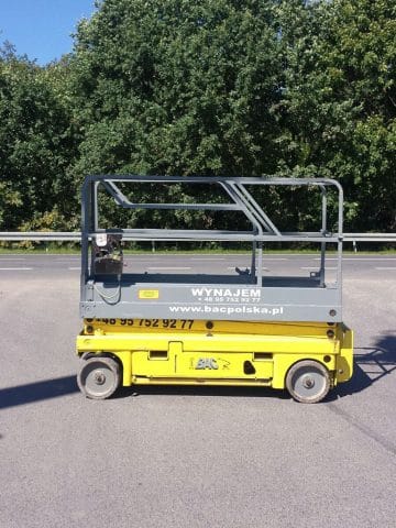 Yellow lift self-propelled platform in the parking lot.