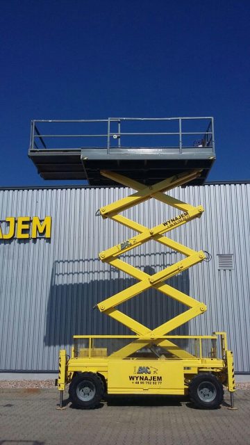 Yellow elevator work platform in front of the building.