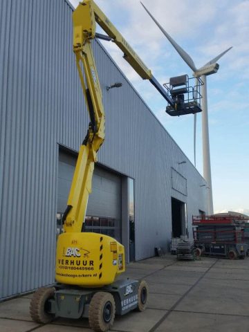 A basket lift and wind turbine next to the hall.