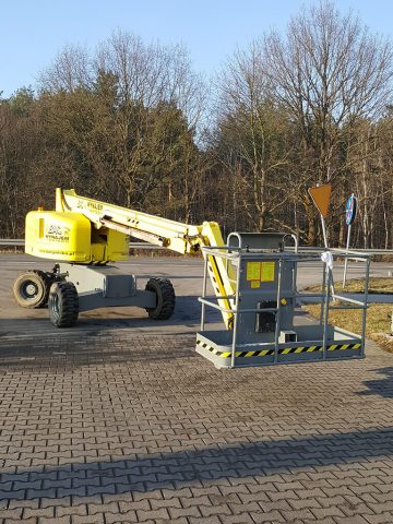 An aerial lift at a roadside construction site.