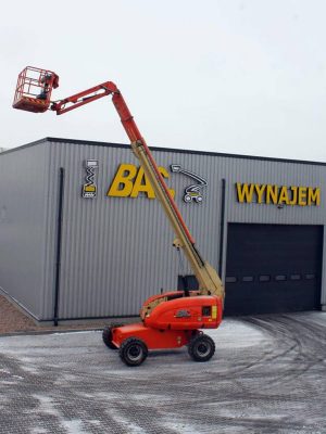 A basket lift in front of a building with a sign reading "RENTAL."