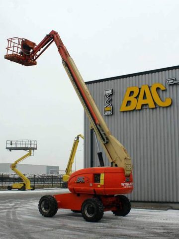 Aerial work platforms on a construction site in winter.