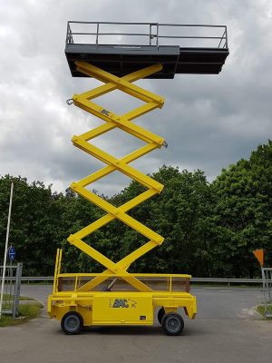 Yellow scissor lift in the parking lot