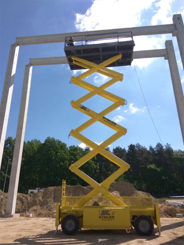 Scissor lift on a construction site during the day.