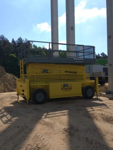 A construction scissor lift at a construction site.