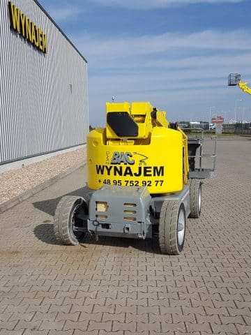 Yellow BAC aerial lift by the "RENT" building.