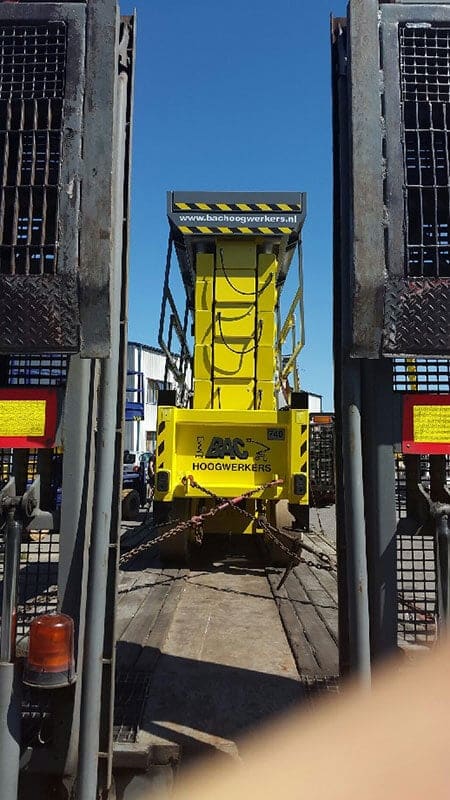 Lift on a trailer between loading ramps.