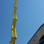 An aerial lift at an industrial building.