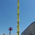 A boom lift at an industrial building.