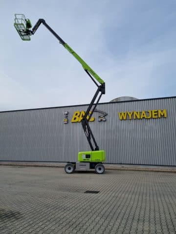 Zoomlion aerial lift in front of a building with a sign reading "Rental."