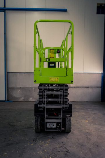Green lift self-propelled platform in the hall.
