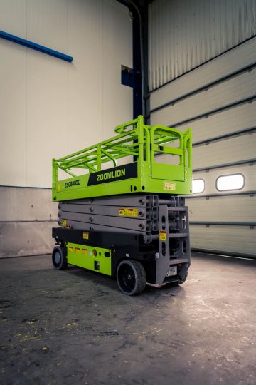 A green Zoomlion self-propelled lift platform in storage.