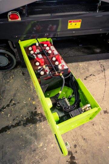Batteries in the open green box of the electric vehicle.