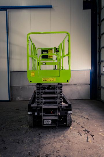 Green elevator work platform in the warehouse.