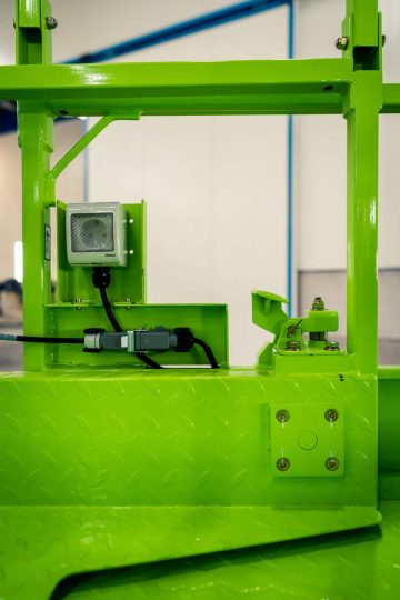 Green industrial machine on the shop floor.