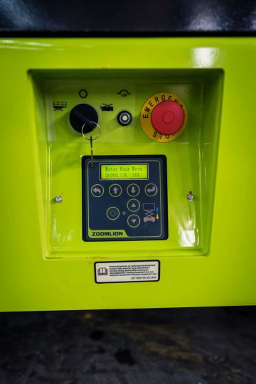 Zoomlion machine control panel with emergency stop button.