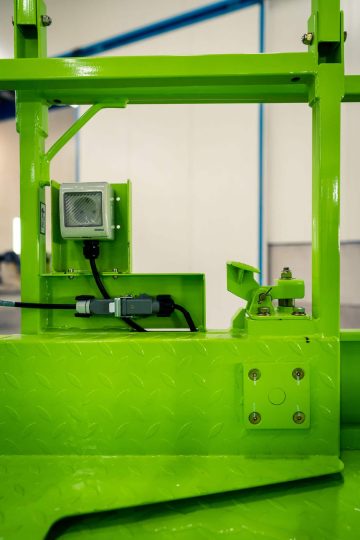 Green industrial machine in a manufacturing plant.