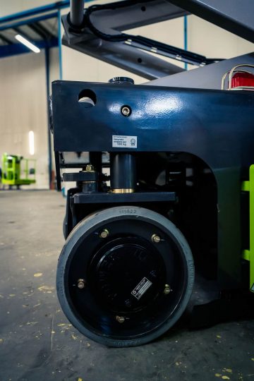 The wheel of an industrial vehicle on the shop floor.