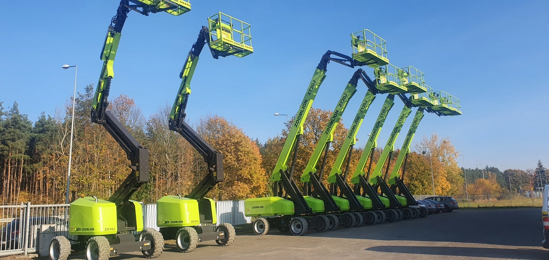 A row of Zoomlion aerial work platforms in the parking lot.