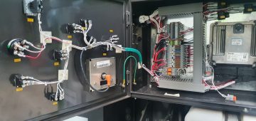 Electrical cabinet with wires and switches.