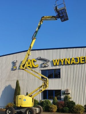 Yellow basket lift in front of the building "Rental".