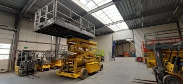 Scissor lifts in an industrial warehouse.