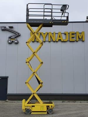 Yellow lift platform in front of the hall with the sign "BAC RENTAL."