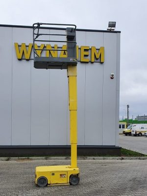 A basket lift in front of a building with a sign reading "RENTAL."