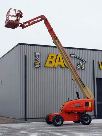 A basket lift in front of an industrial hall.