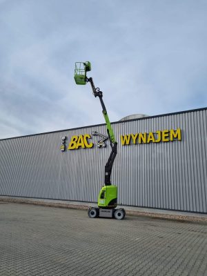 Zoomlion aerial lift in front of building with rental sign.