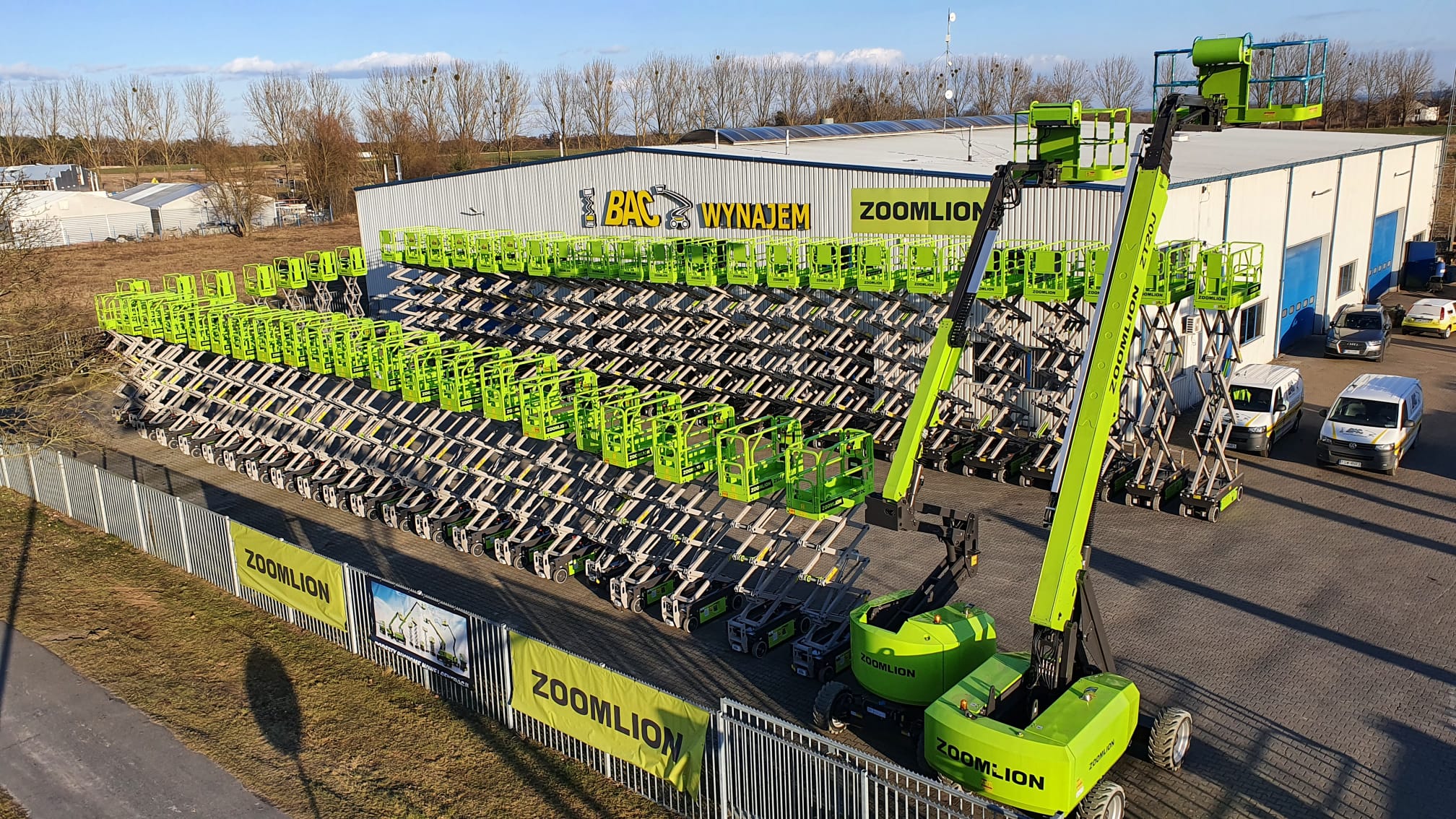 Zoomlion aerial work platforms parked in front of the company's building.