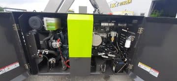 The engine of a generator set with the door open.