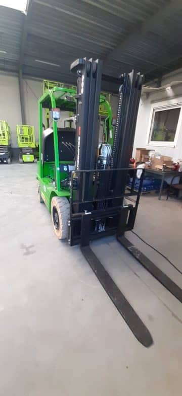 Green forklift in the warehouse.