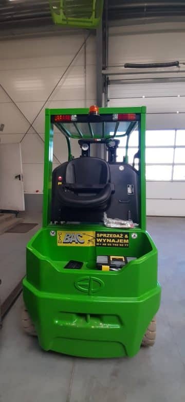 Green forklift in the warehouse.