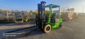 Green forklift on construction site