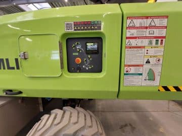 Industrial machine control panel with safety markings.