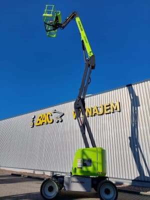 Zoomlion aerial lift in front of building with rental sign.